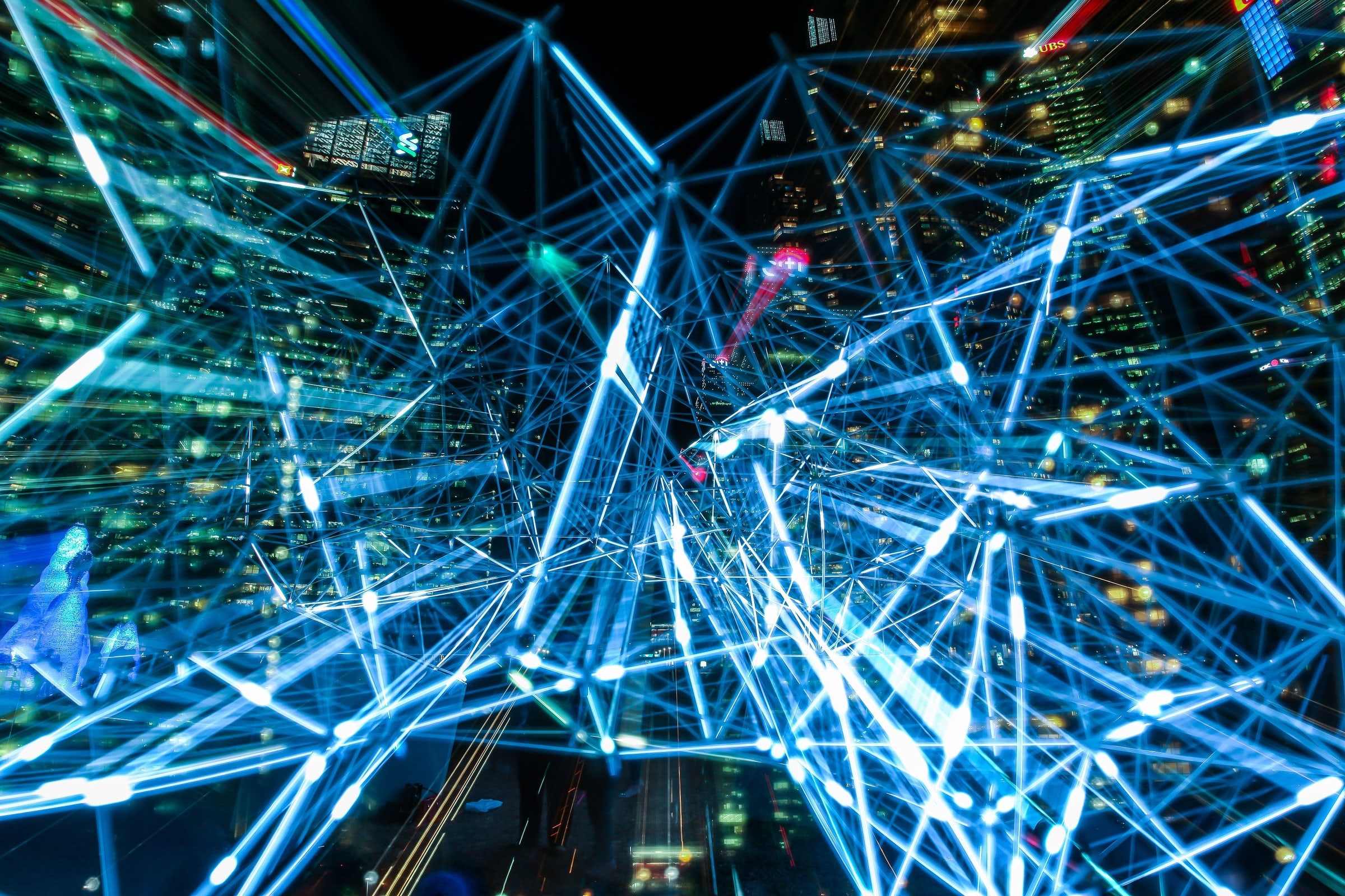 A city illuminated by a network of connected digital light paths.